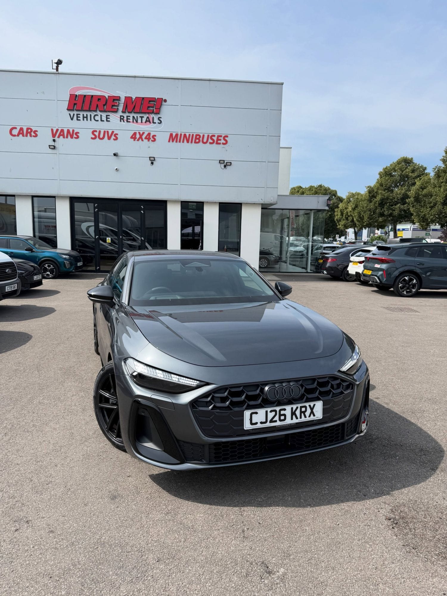 Hire Me Cardiff Branch Business Saloon Hire A black four-door saloon parked outside the Hire Me! Vehicle Rentals branch in Cardiff.